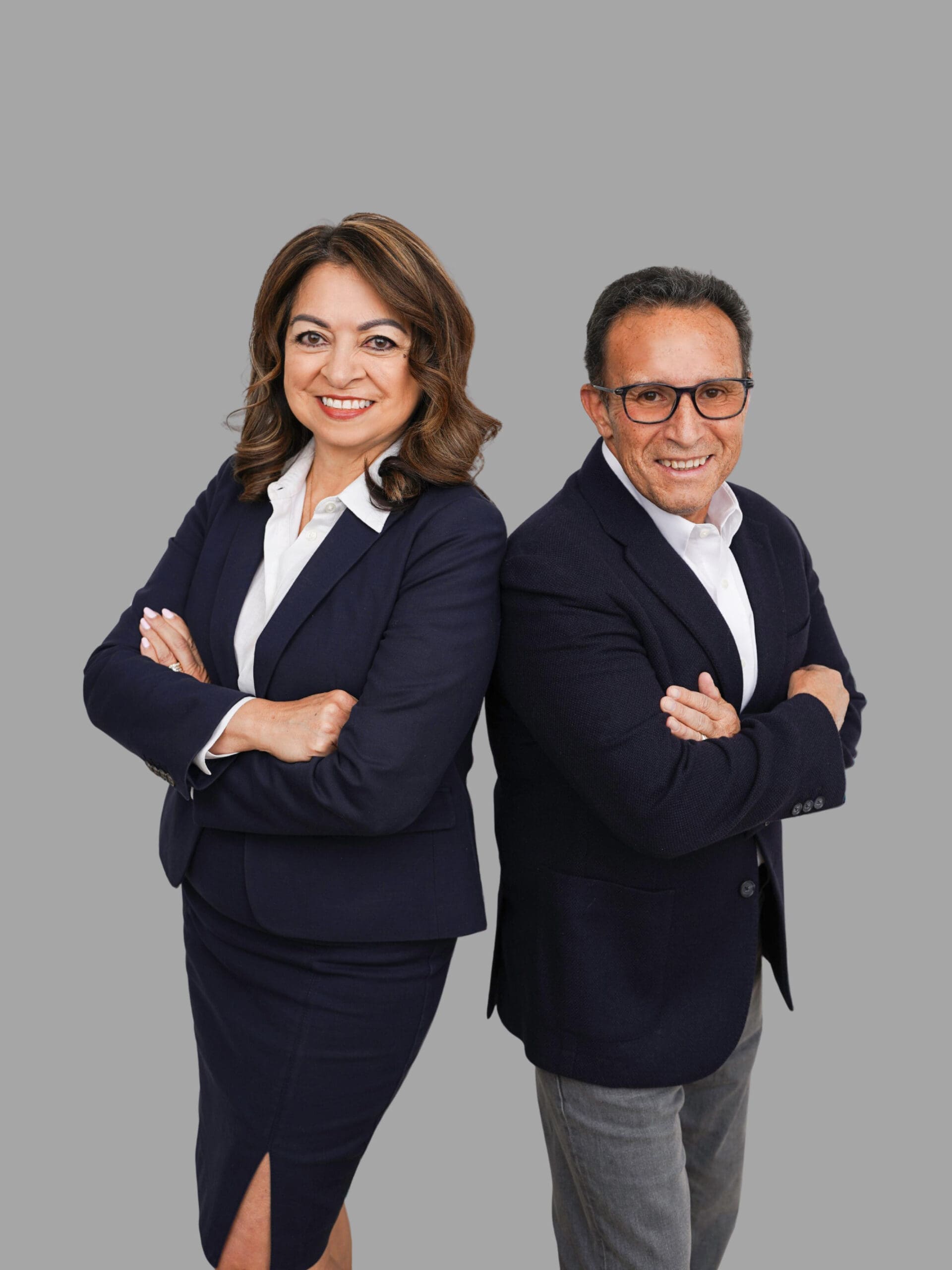 Minority-owned paper supplier owners, a man and woman, pose confidently.