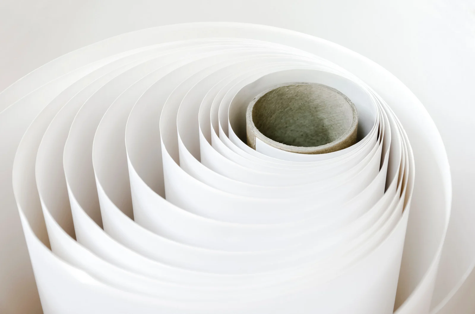 Rolled white paper tubes, showcasing a paper and packaging supplier's materials.